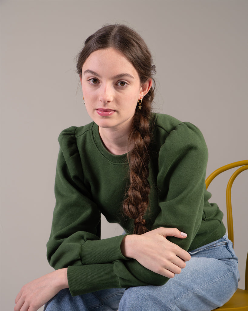 Woman in a green puffed shoulder sweatshirt