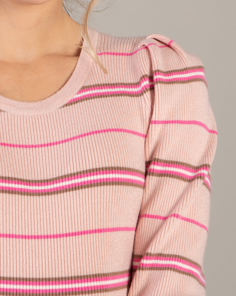 Woman in a pink striped long sleeve top