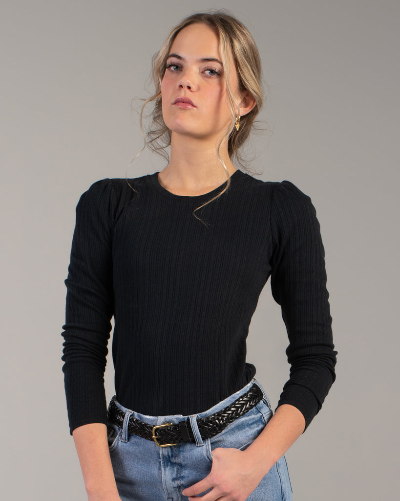 Woman in a black ribbed knit long sleeve tee