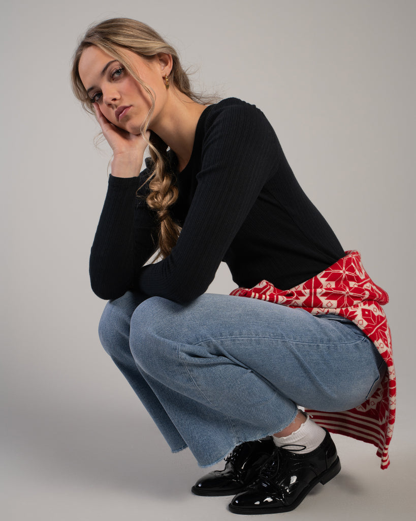 Woman in a black ribbed knit long sleeve tee