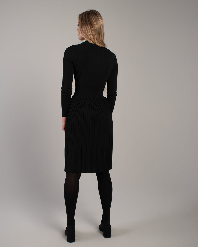 Woman in a black ribbed-knit long sleeve dress