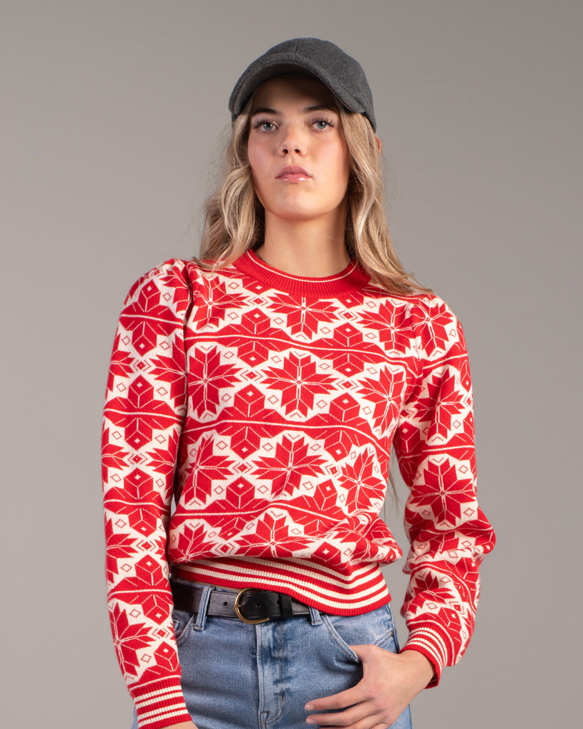 Woman in a red and white snowflake design sweater