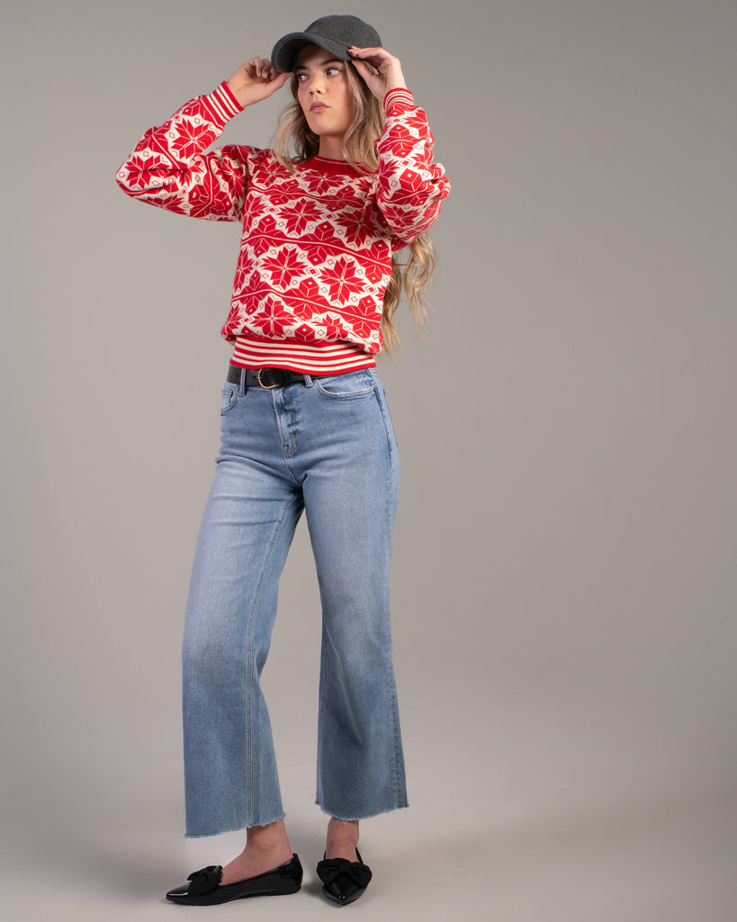 Woman in a red and white snowflake design sweater