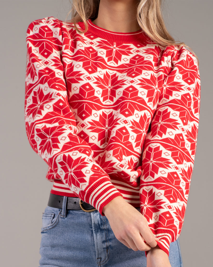 Woman in a red and white snowflake design sweater