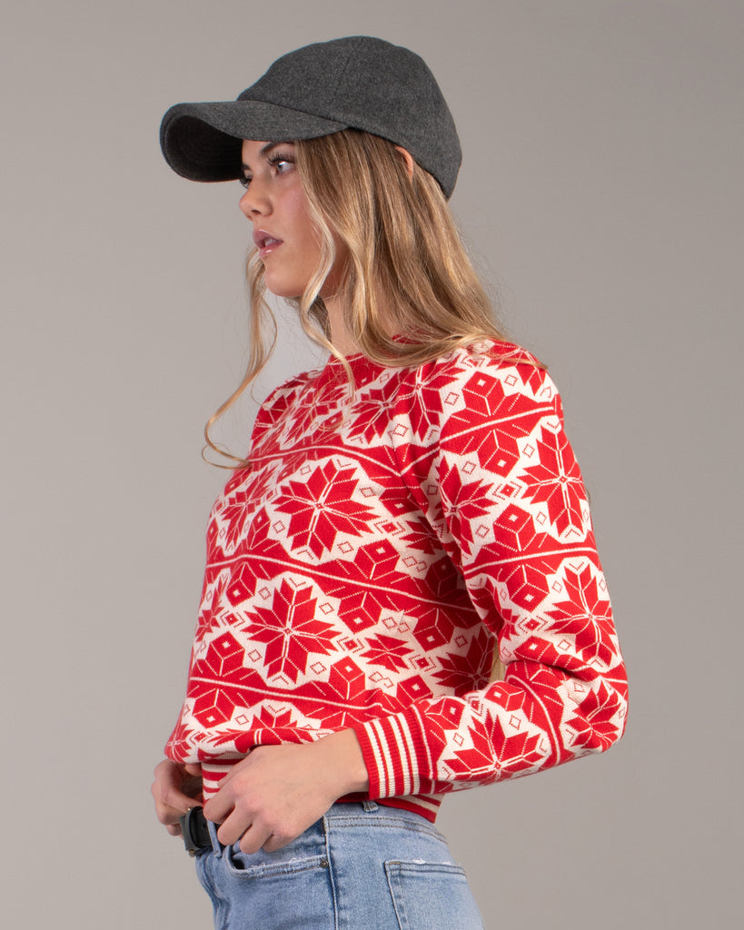 Woman in a red and white snowflake design sweater