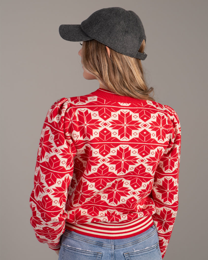 Woman in a red and white snowflake design sweater