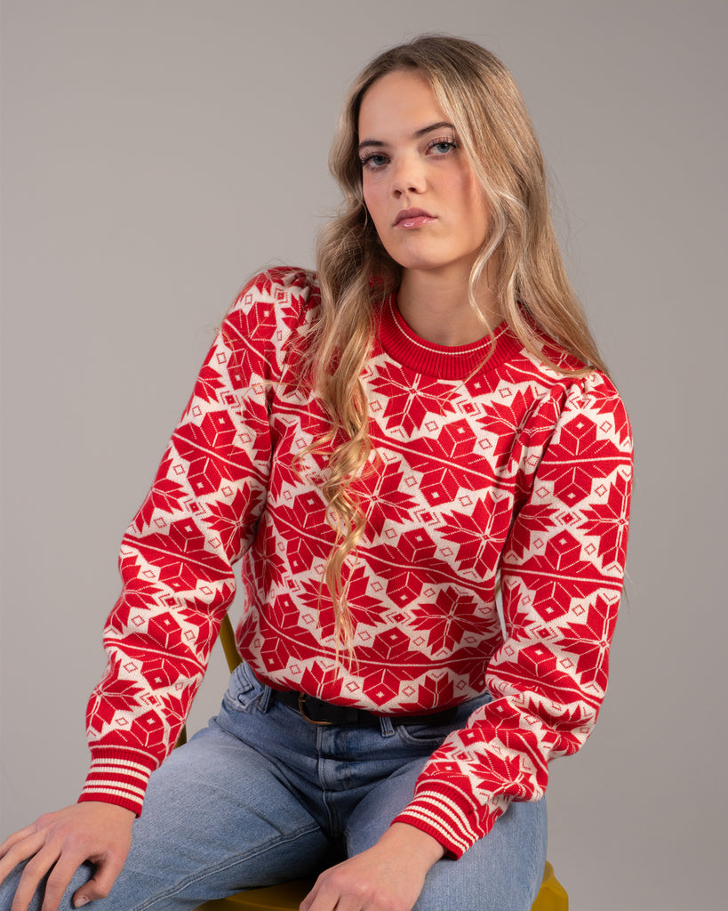 Woman in a red and white snowflake design sweater