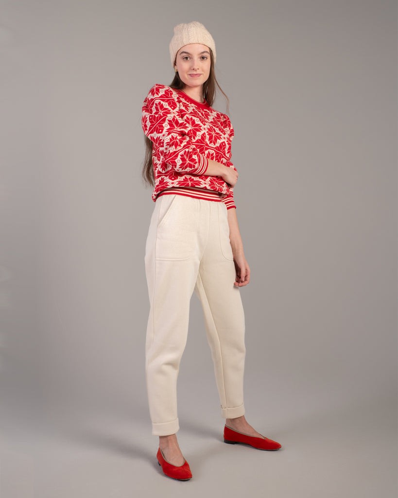 Woman in a red and white snowflake design sweater