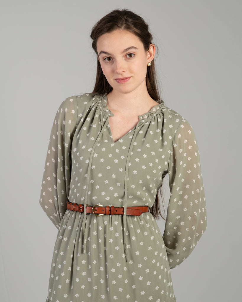 Woman in a green long sleeve midi-length dress