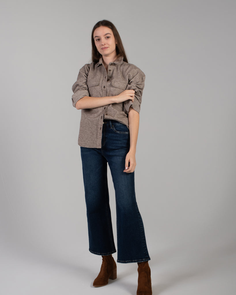 Woman in a brown long sleeve buttondown sweater