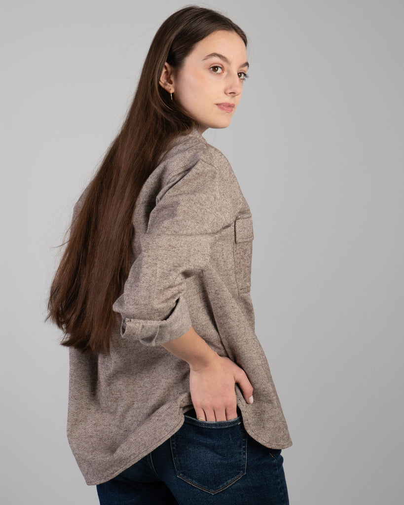 Woman in a brown long sleeve buttondown sweater