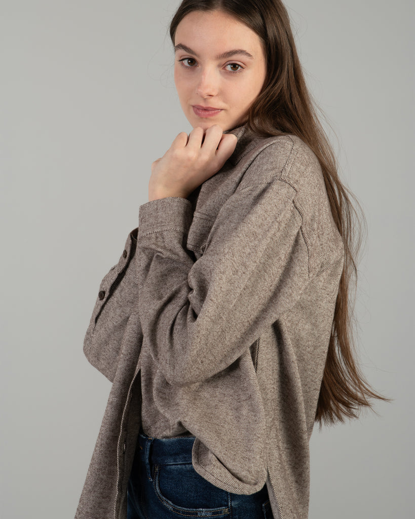 Woman in a brown long sleeve buttondown sweater