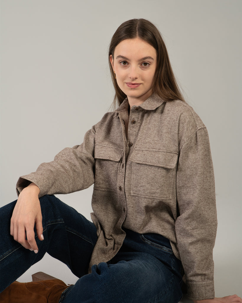 Woman in a brown long sleeve buttondown sweater