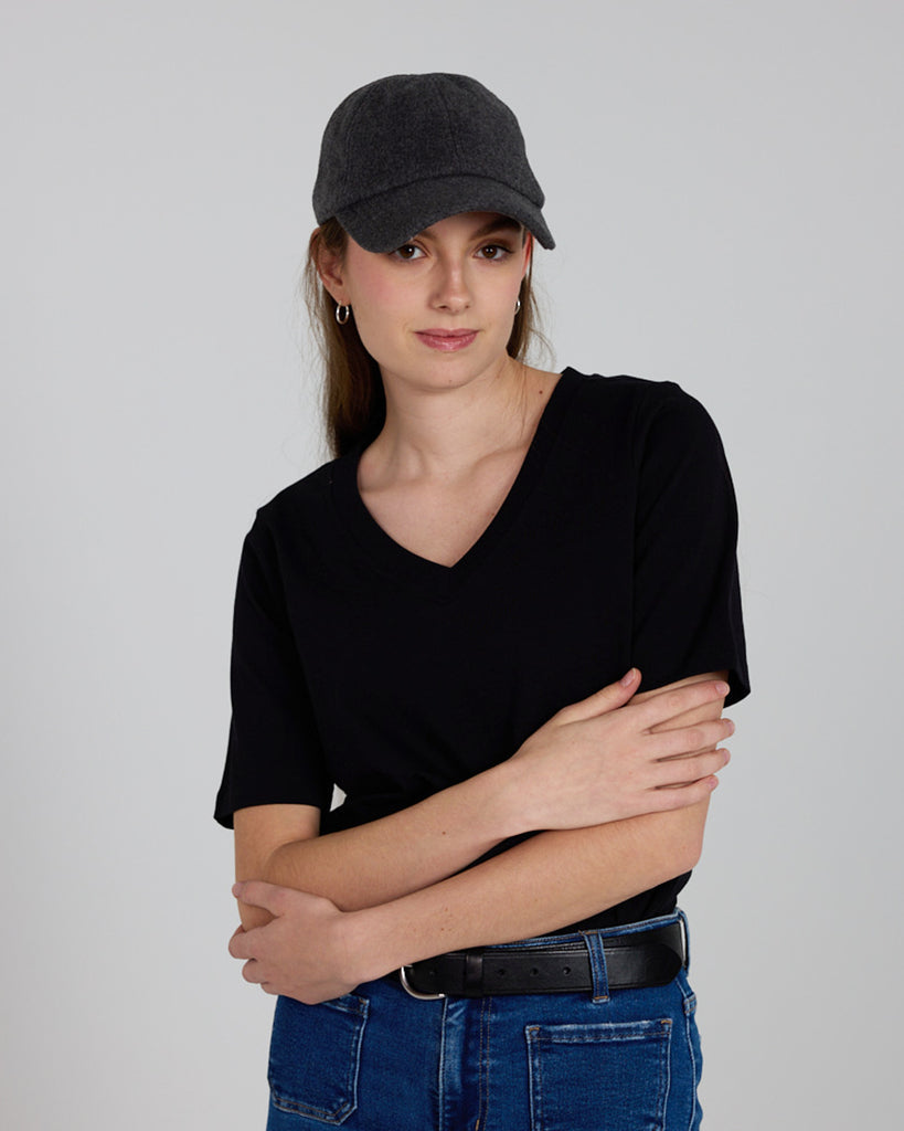 Model wearing a black relaxed fit, short sleeve, v-neck basic tee.