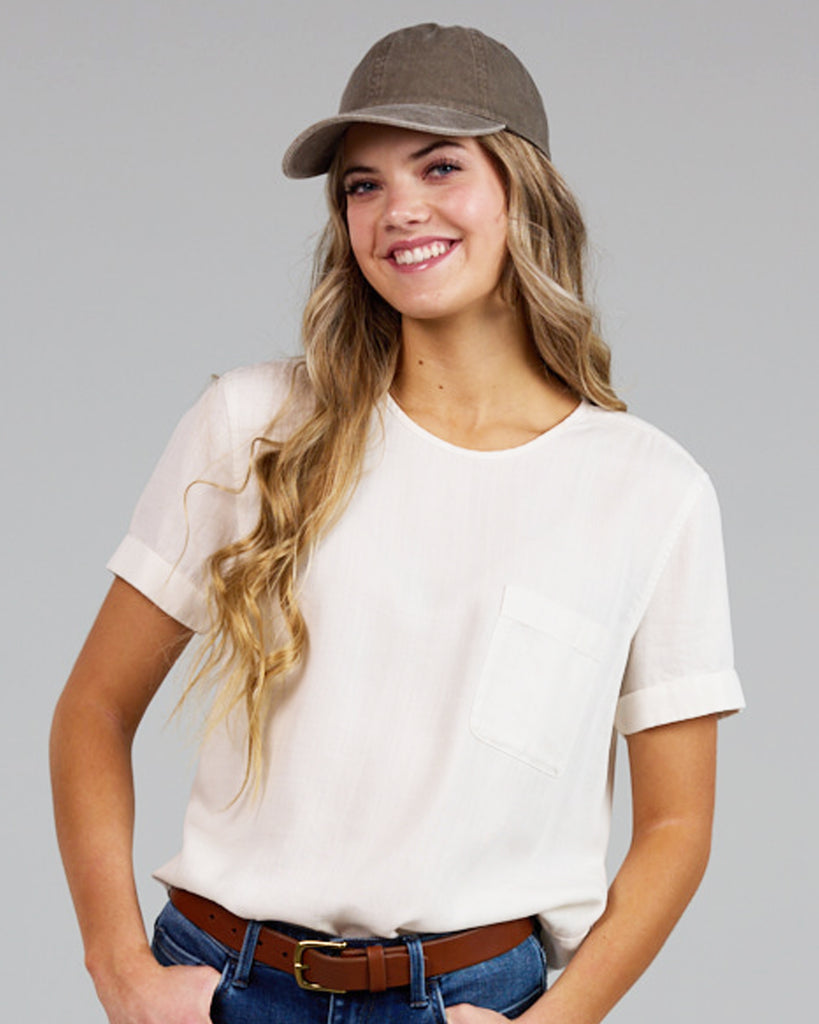 Model wearing a white short sleeve with cuff, round neck loose fitting blouse.