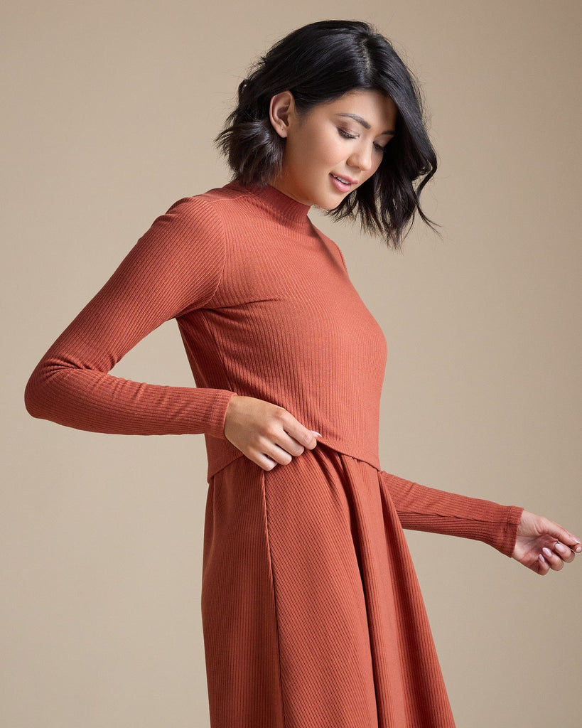 Woman in a burnt orange long sleeve ribbed cropped tee