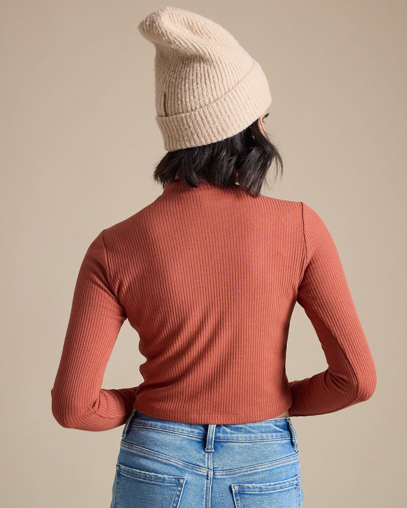 Woman in a burnt orange long sleeve ribbed cropped tee