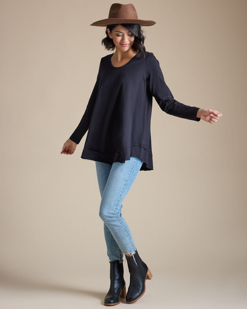 Woman in a black long sleeve flowy top