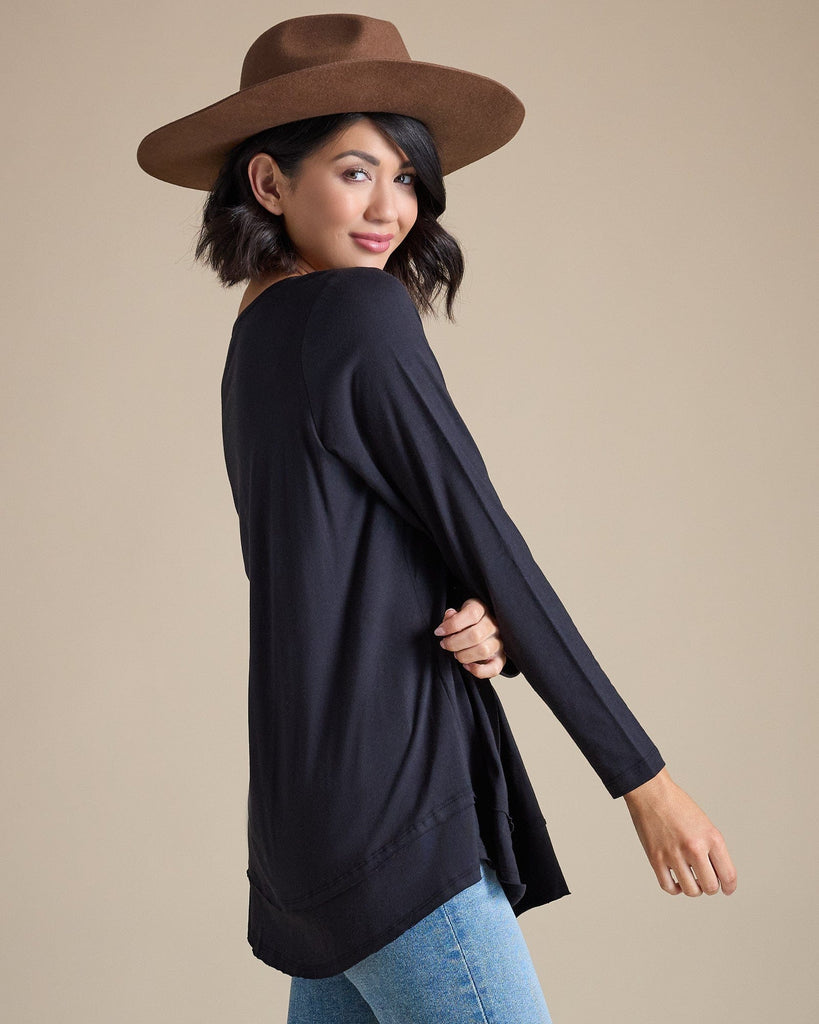 Woman in a black long sleeve flowy top